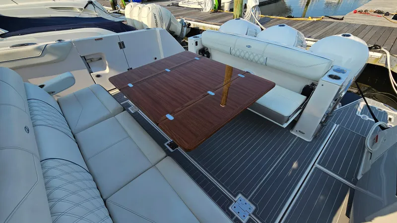  Yacht Photos Pics 2021 Regal 38 SAV boat interior with elegant seating and wooden table.