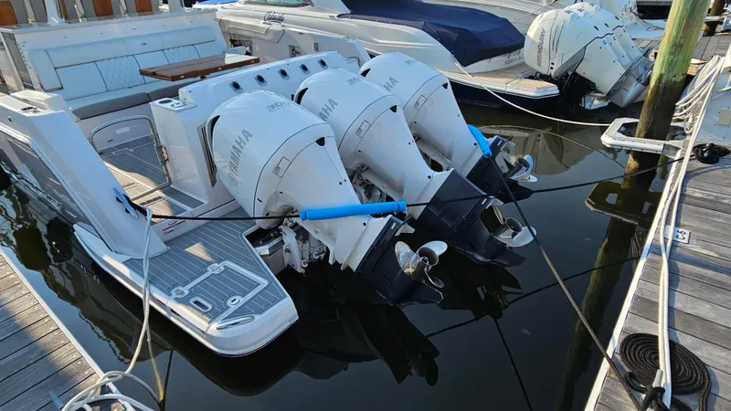  Yacht Photos Pics 2021 Regal 38 SAV with triple Yamaha outboard engines docked at marina.