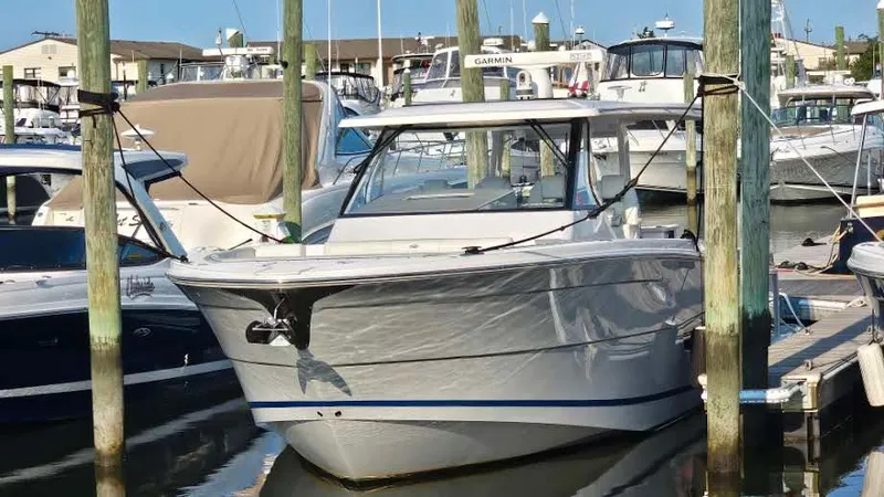  Yacht Photos Pics 2021 Regal 38 SAV boat docked in a marina, surrounded by other vessels.