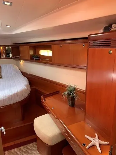 Karuna Ss Yacht Photos Pics Interior of 2007 Beneteau 49' Cruiser with wooden cabinetry and cozy sleeping area.