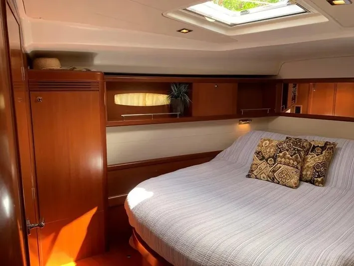 Karuna Ss Yacht Photos Pics Luxurious cabin interior of a 2007 Beneteau 49' Cruiser with elegant wood finish.