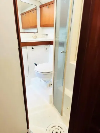 Karuna Ss Yacht Photos Pics 2007 Beneteau 49' Cruiser bathroom with wooden cabinets and shower.