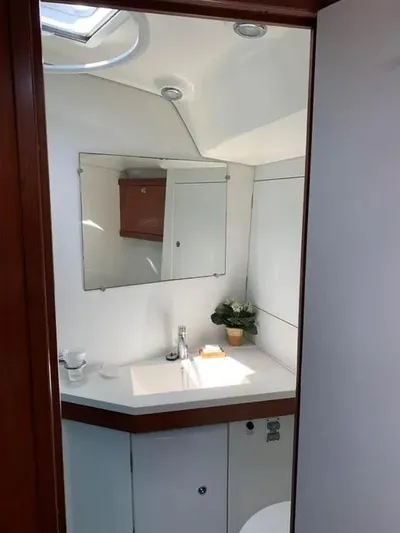Karuna Ss Yacht Photos Pics 2007 Beneteau 49' Cruiser bathroom with modern sink, mirror, and storage.