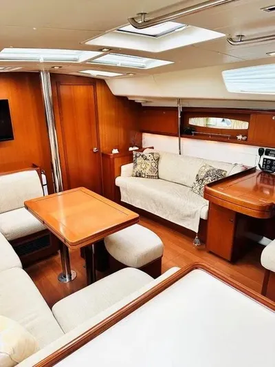 Karuna Ss Yacht Photos Pics Luxurious interior of a 2007 Beneteau 49' Cruiser yacht with elegant wood finishes.