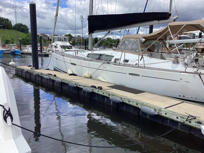 Karuna Ss Yacht Photos Pics 2007 Beneteau 49' Cruiser yacht docked at marina, calm water reflections.