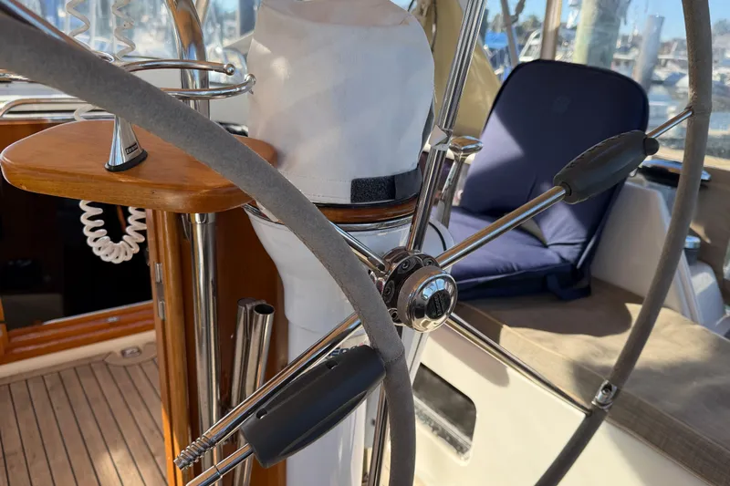Sirius Yacht Photos Pics Steering wheel of a 2011 Passport 470 Center Cockpit sailboat, featuring a comfortable cockpit area.