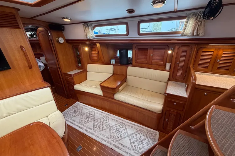 Sirius Yacht Photos Pics Luxurious interior of 2011 Passport 470 Center Cockpit yacht with wood finish and seating area.