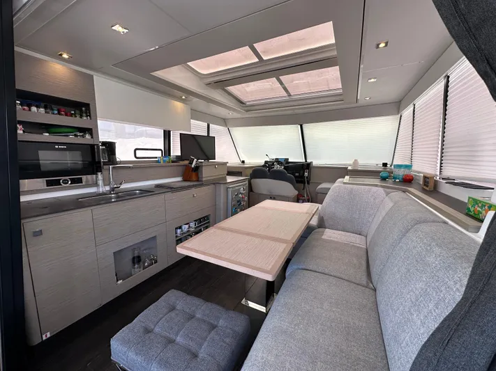 Vie Pure Yacht Photos Pics Luxurious interior of 2021 Fountaine Pajot MY4.S yacht with modern kitchen and seating area.