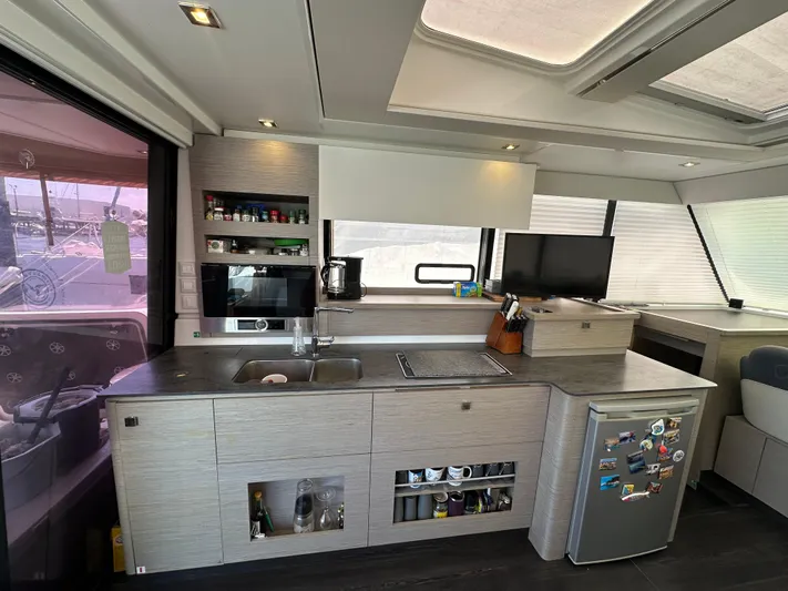 Vie Pure Yacht Photos Pics Modern kitchen interior of 2021 Fountaine Pajot MY4.S yacht with appliances and sleek design.
