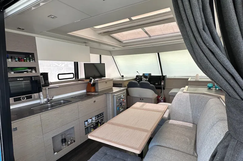 Vie Pure Yacht Photos Pics Luxurious interior of 2021 Fountaine Pajot MY4.S yacht with modern kitchen and seating area.