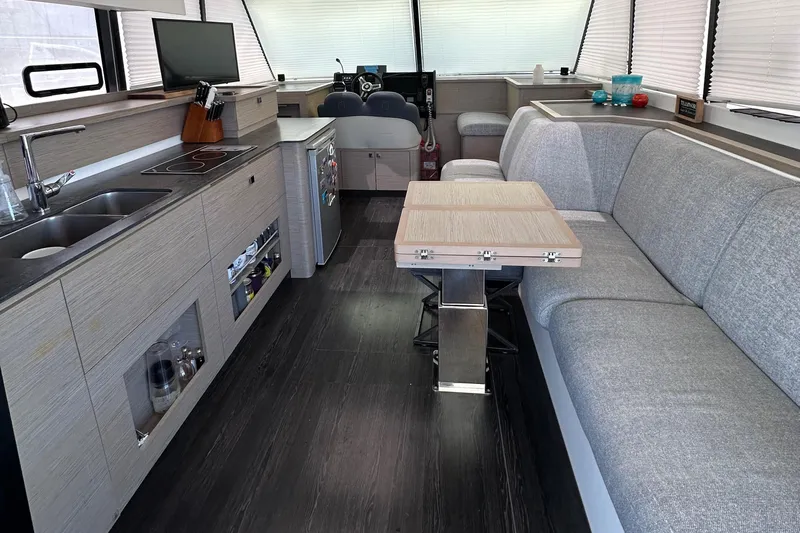 Vie Pure Yacht Photos Pics Modern interior of 2021 Fountaine Pajot MY4.S yacht with sleek kitchen and seating area.