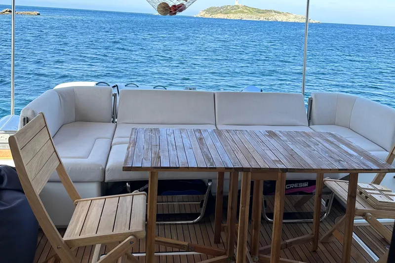 Vie Pure Yacht Photos Pics Luxurious 2021 Fountaine Pajot MY4.S yacht deck with seating, wooden table, and ocean view.