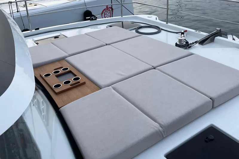 Vie Pure Yacht Photos Pics Sunbathing deck on 2021 Fountaine Pajot MY4.S yacht with cushioned seating and cup holders.