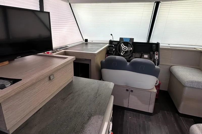 Vie Pure Yacht Photos Pics Interior of 2021 Fountaine Pajot MY4.S yacht with helm, seating, and TV.