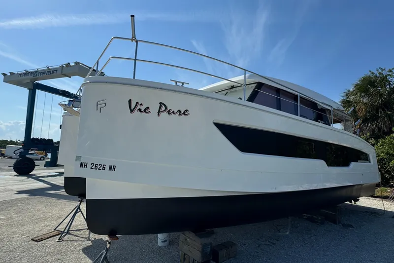 Vie Pure Yacht Photos Pics 2021 Fountaine Pajot MY4.S yacht on land, named "Vie Pure," under clear blue sky.