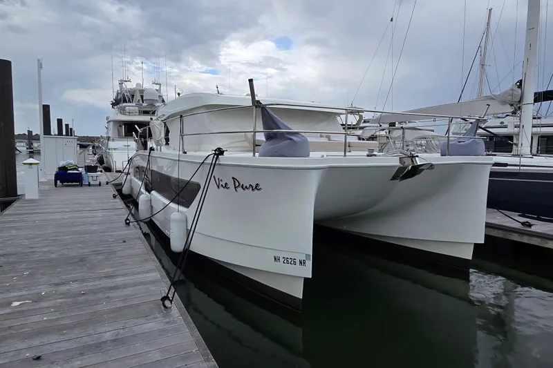 Vie Pure Yacht Photos Pics 2021 Fountaine Pajot MY4.S catamaran docked at marina under cloudy sky.