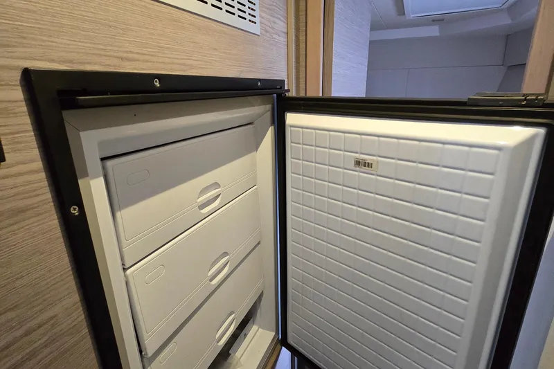 Vie Pure Yacht Photos Pics Open refrigerator on 2021 Fountaine Pajot MY4.S yacht, showcasing interior storage drawers.