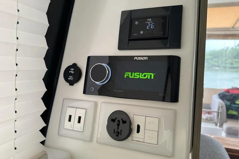 Vie Pure Yacht Photos Pics Control panel on 2021 Fountaine Pajot MY4.S yacht with Fusion audio system and power outlets.