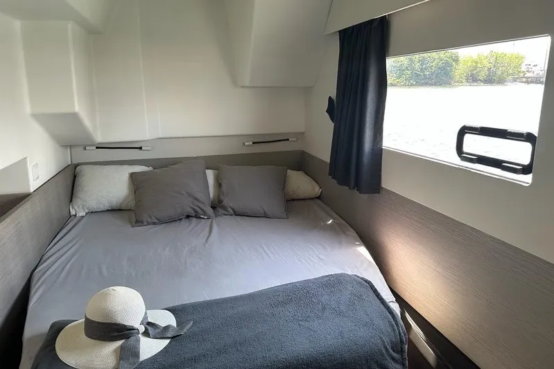 Vie Pure Yacht Photos Pics Cozy cabin interior of 2021 Fountaine Pajot MY4.S with bed and window view.
