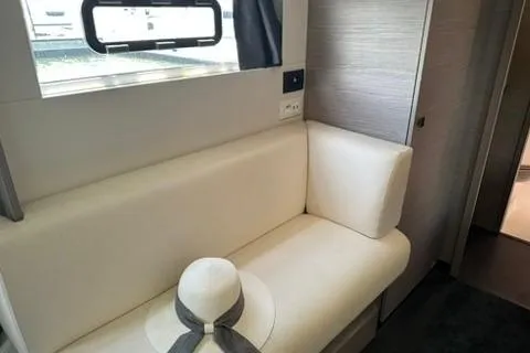 Vie Pure Yacht Photos Pics Interior of 2021 Fountaine Pajot MY4.S yacht with white seating and a hat.