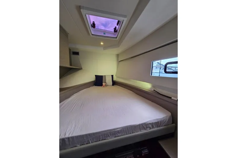 Vie Pure Yacht Photos Pics Luxurious bedroom interior of 2021 Fountaine Pajot MY4.S yacht with skylight and modern design.