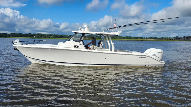 Blown Dough Yacht Photos Pics 2023 Pursuit S 358 Sport boat cruising on a calm river under a blue sky.