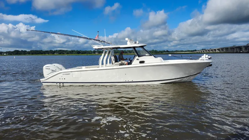 Blown Dough Yacht Photos Pics 2023 Pursuit S 358 Sport boat on calm water under a blue sky.