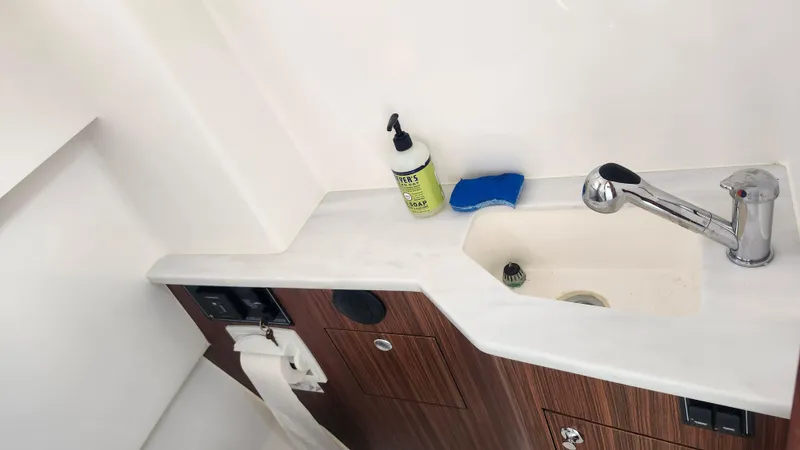 Blown Dough Yacht Photos Pics 2023 Pursuit S 358 Sport boat bathroom sink with faucet and soap.