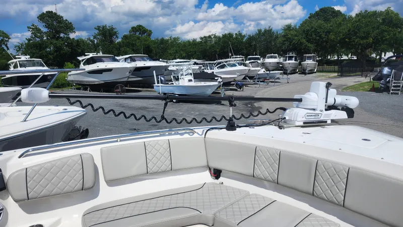 Blown Dough Yacht Photos Pics 2023 Pursuit S 358 Sport boat in marina, surrounded by other boats under a blue sky.