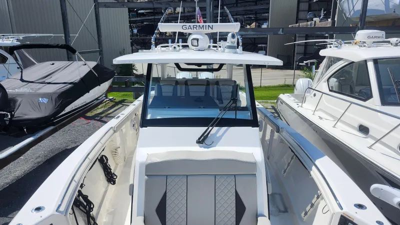 Blown Dough Yacht Photos Pics 2023 Pursuit S 358 Sport boat docked, featuring Garmin equipment and sleek design.