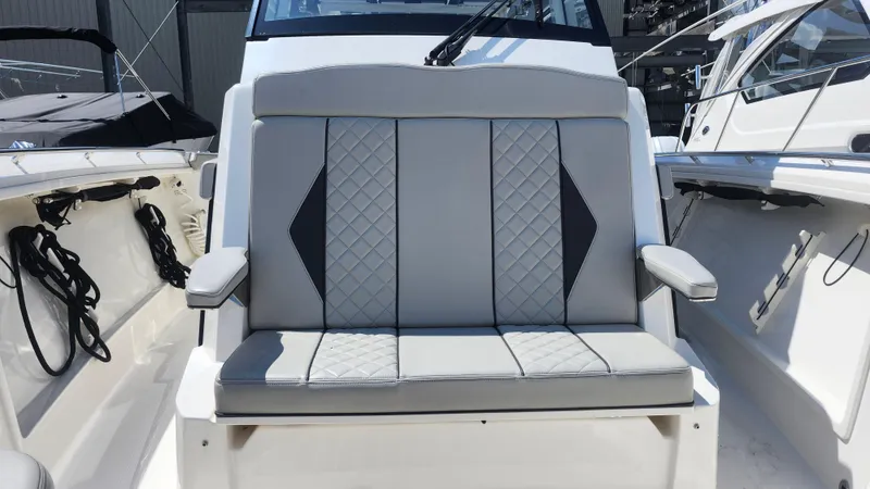 Blown Dough Yacht Photos Pics 2023 Pursuit S 358 Sport boat seat with quilted design and armrests.