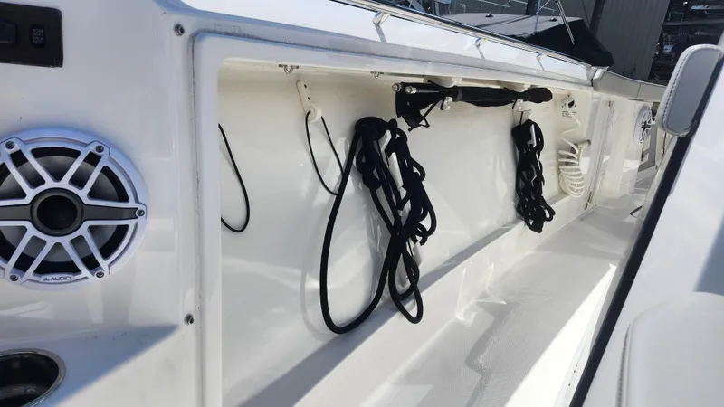 Blown Dough Yacht Photos Pics 2023 Pursuit S 358 Sport boat interior with speaker and storage compartment.