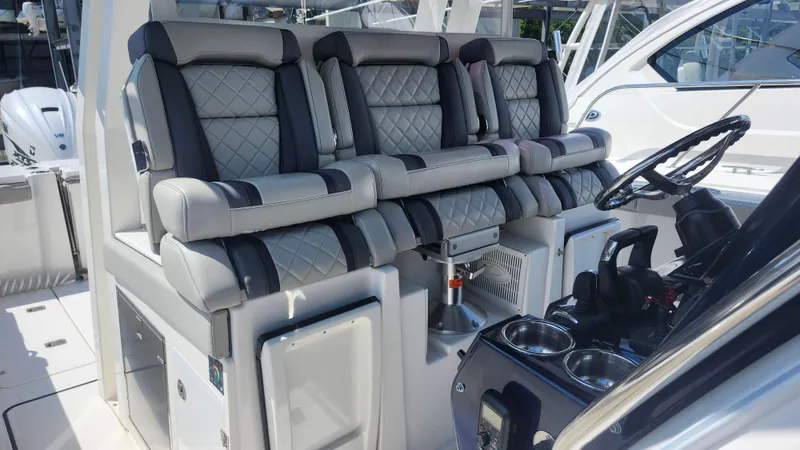 Blown Dough Yacht Photos Pics 2023 Pursuit S 358 Sport boat interior with luxurious seating and modern helm controls.