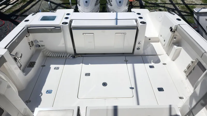 Blown Dough Yacht Photos Pics 2023 Pursuit S 358 Sport boat deck with storage compartments and seating area.
