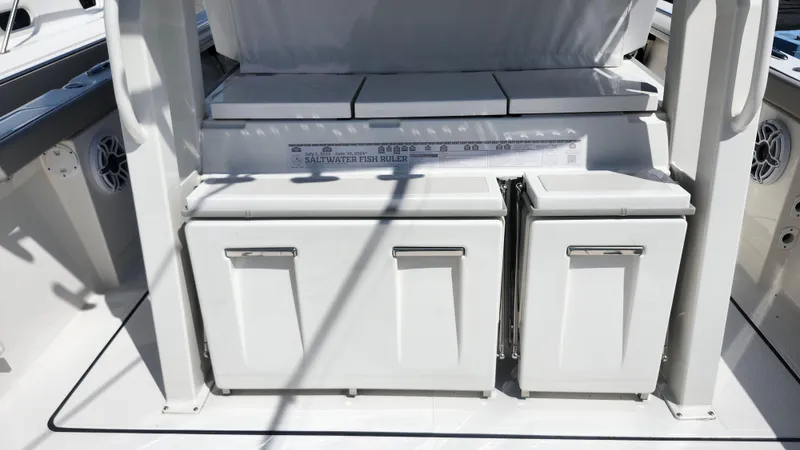 Blown Dough Yacht Photos Pics 2023 Pursuit S 358 Sport boat interior with storage compartments and fish ruler.