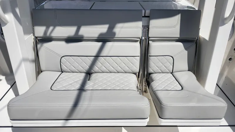 Blown Dough Yacht Photos Pics 2023 Pursuit S 358 Sport boat seating with quilted gray upholstery.