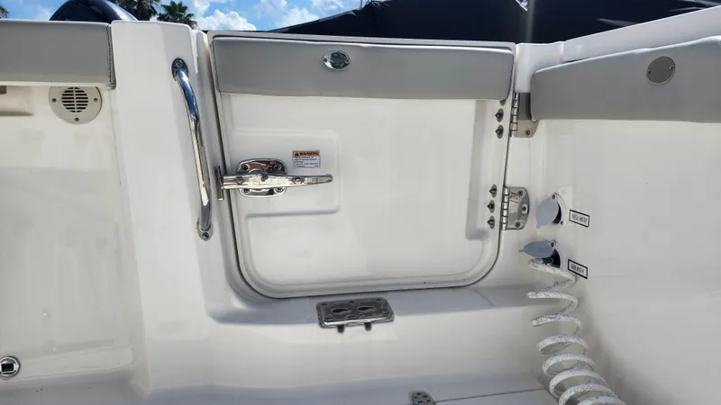 Blown Dough Yacht Photos Pics 2023 Pursuit S 358 Sport boat interior, featuring a sleek white door and chrome handle.