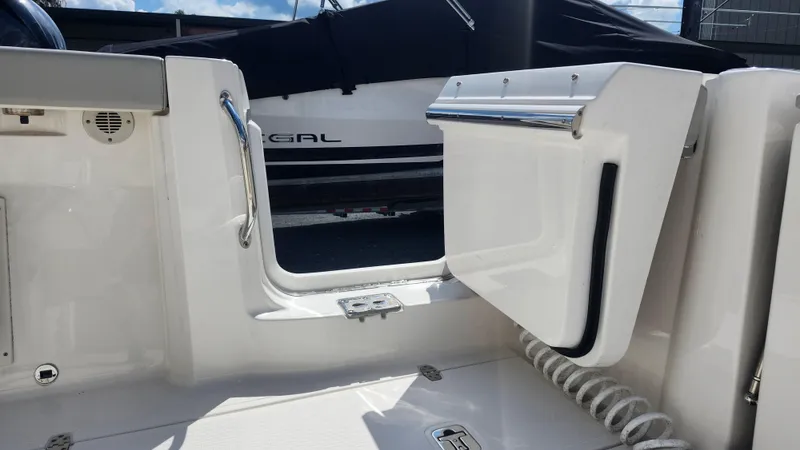 Blown Dough Yacht Photos Pics 2023 Pursuit S 358 Sport boat interior with open door and coiled rope.