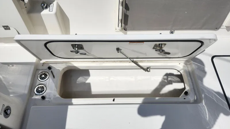 Blown Dough Yacht Photos Pics Open storage compartment on 2023 Pursuit S 358 Sport boat deck.