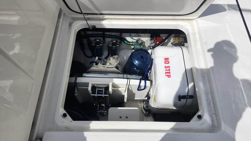 Blown Dough Yacht Photos Pics 2023 Pursuit S 358 Sport boat compartment with equipment and "No Step" warning label.