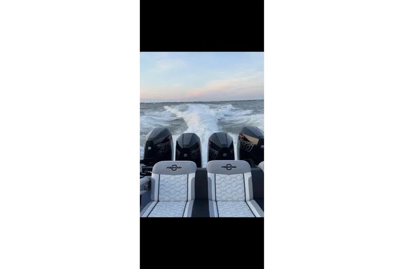 A Salt Weapon Yacht Photos Pics 2024 Fountain 38 SC boat with powerful engines cruising on open water.