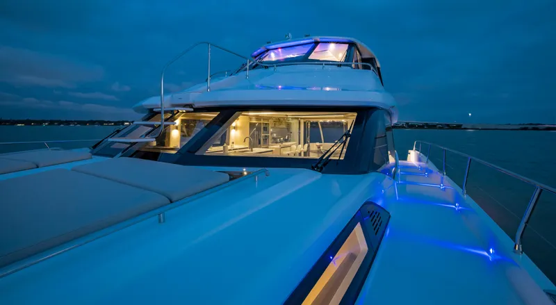 Aquila 70 Yacht Photos Pics Aquila 70 Luxury yacht, 2026 model, illuminated at night on the water.
