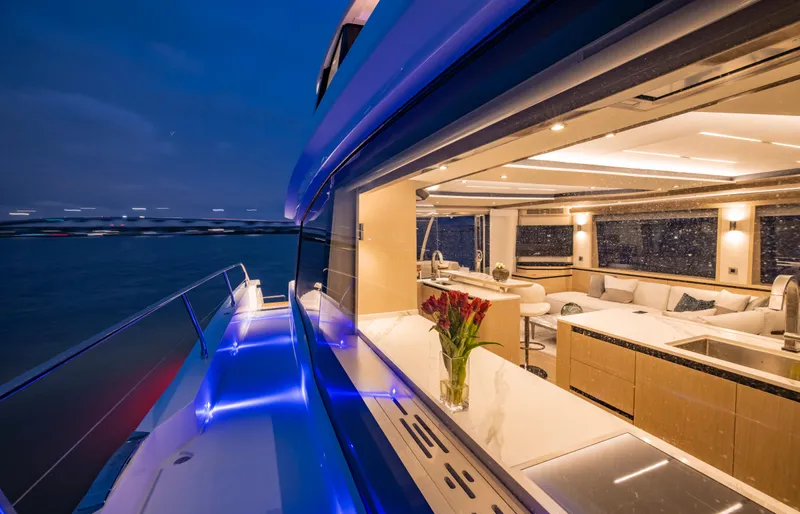 Aquila 70 Yacht Photos Pics Luxurious 2026 Aquila 70 yacht interior with modern design and ambient lighting at dusk.