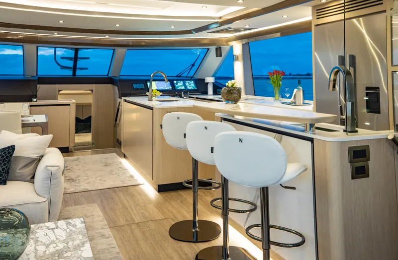 Aquila 70 Yacht Photos Pics Luxurious interior of 2026 Aquila 70 yacht with modern kitchen and seating area.