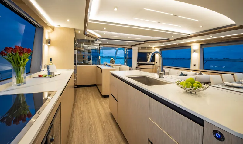 Aquila 70 Yacht Photos Pics Luxurious interior of 2026 Aquila 70 yacht with modern kitchen and panoramic windows.