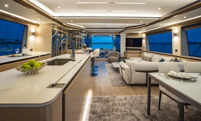Aquila 70 Yacht Photos Pics Luxurious interior of 2026 Aquila 70 yacht with modern kitchen and elegant seating area.