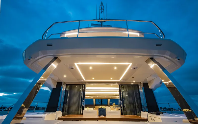 Aquila 70 Yacht Photos Pics Aquila 70 Luxury yacht, 2026 model, illuminated deck at dusk.