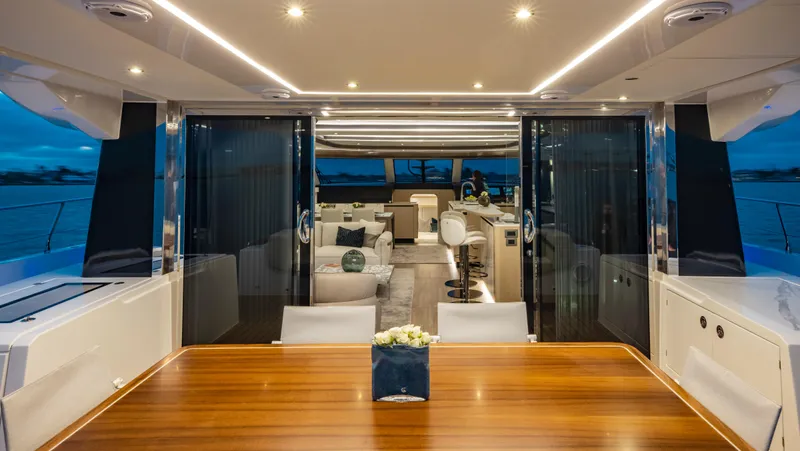 Aquila 70 Yacht Photos Pics Luxurious interior of 2026 Aquila 70 yacht, featuring elegant dining and seating areas.