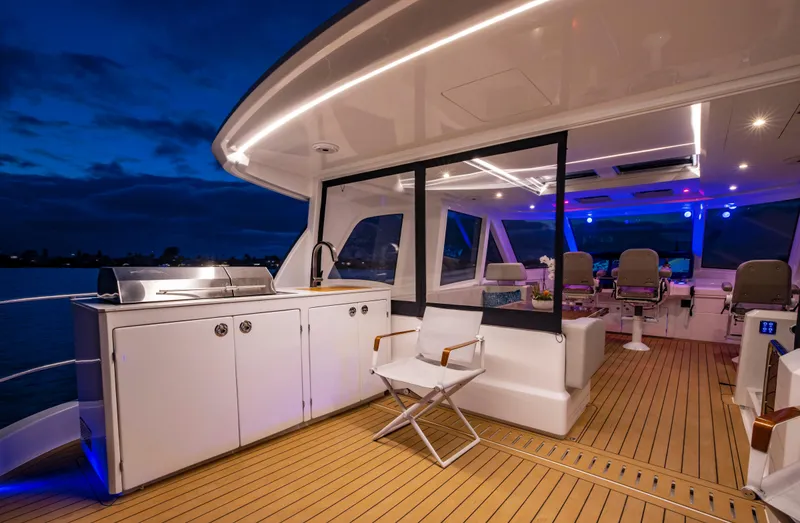 Aquila 70 Yacht Photos Pics Luxurious 2026 Aquila 70 yacht interior with modern seating and sleek design at dusk.