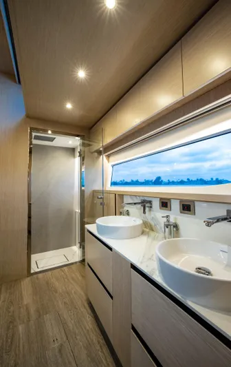 Aquila 70 Yacht Photos Pics Luxurious bathroom interior of 2026 Aquila 70 Luxury yacht with dual sinks and modern fixtures.
